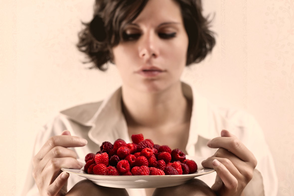 Women holding a bowl of raspberries image