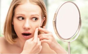 Girl amazingly looking into the mirror